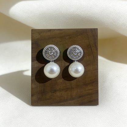 Halo zircon pearl drop earrings on wooden display block