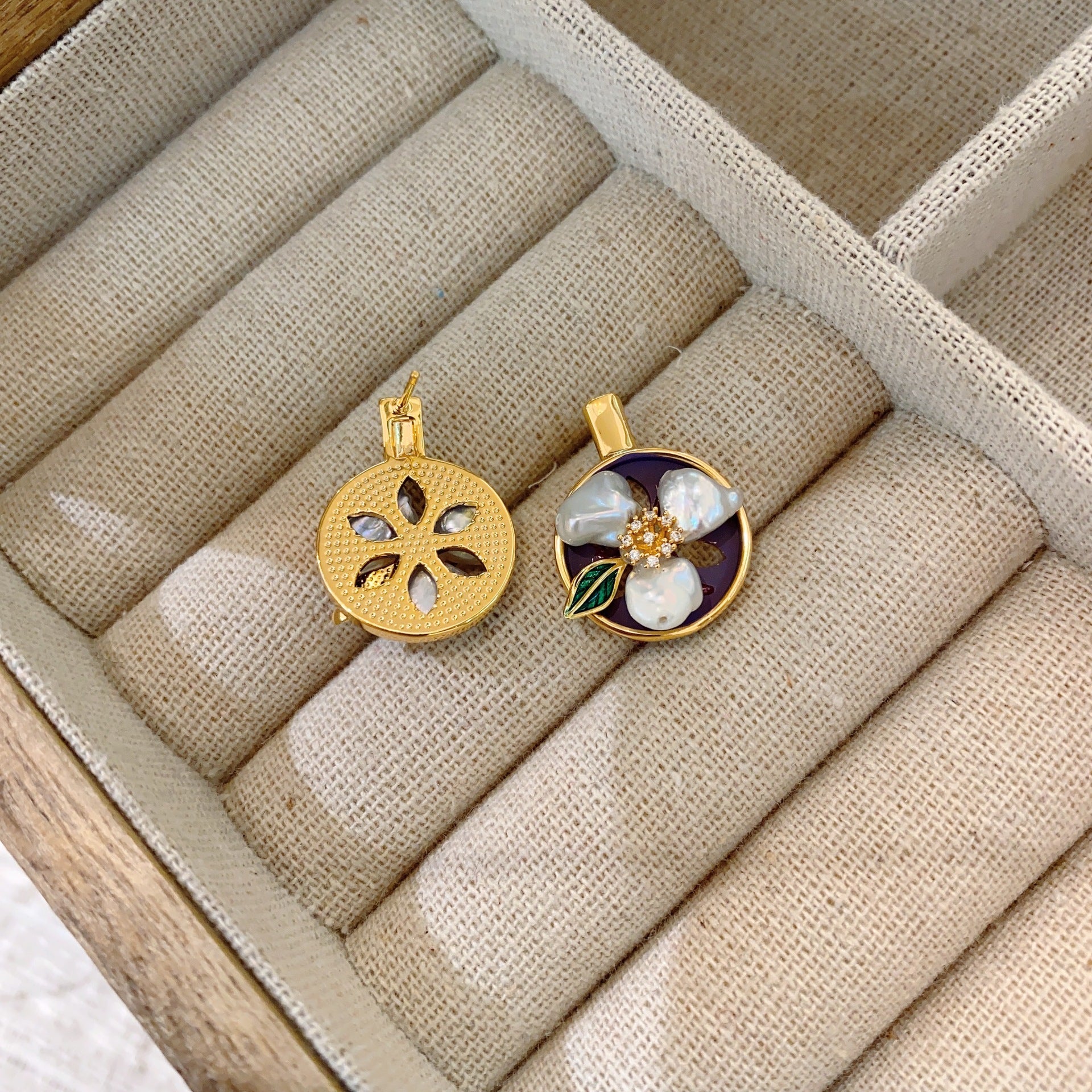 Close-up of Baroque pearl on minimalist vintage earrings.
