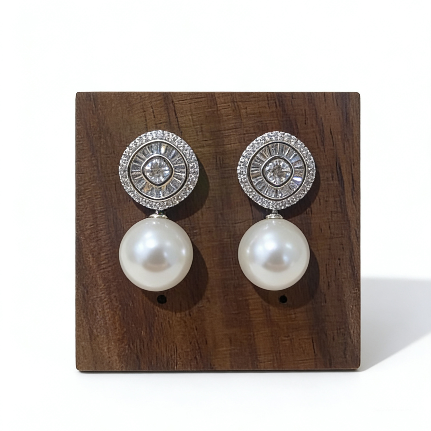 Pearl drop earrings with halo zircon on wooden stand